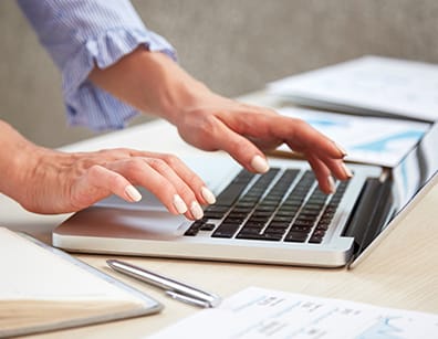 closeup female hands typing laptop keyboard